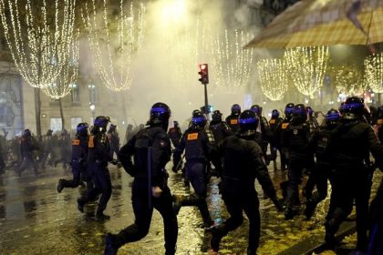 French police use tear gas against fans on Champs-Elysees in Paris